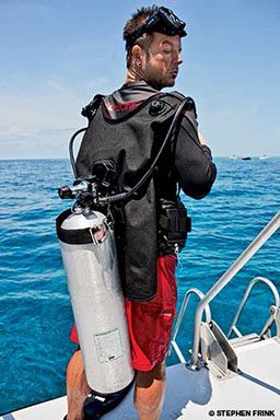 Male scuba diver with a loose tank on his back