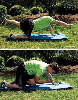 Man in green shirt is on hands and knees performing an exercise