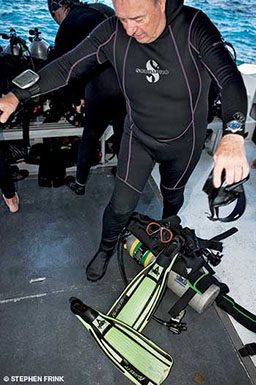 Man in wetsuit gets gear ready