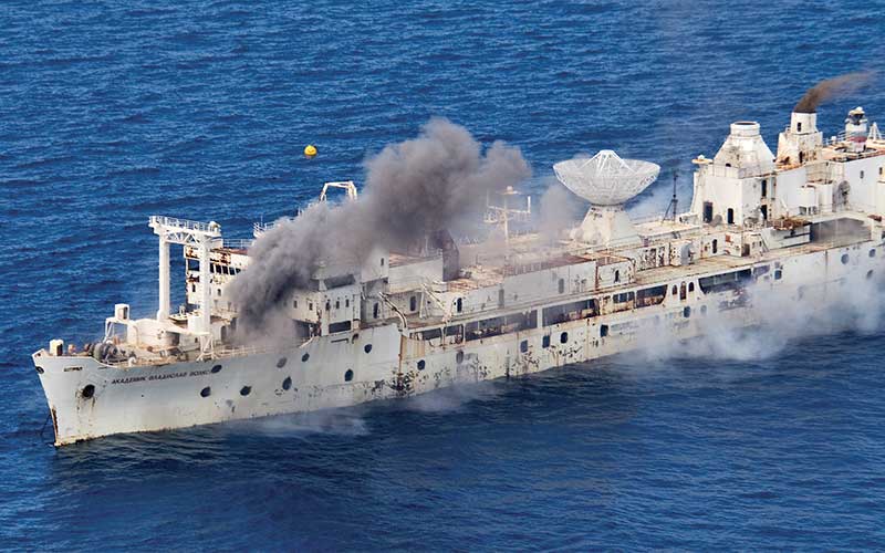 Old white ship implodes and gives off smoke