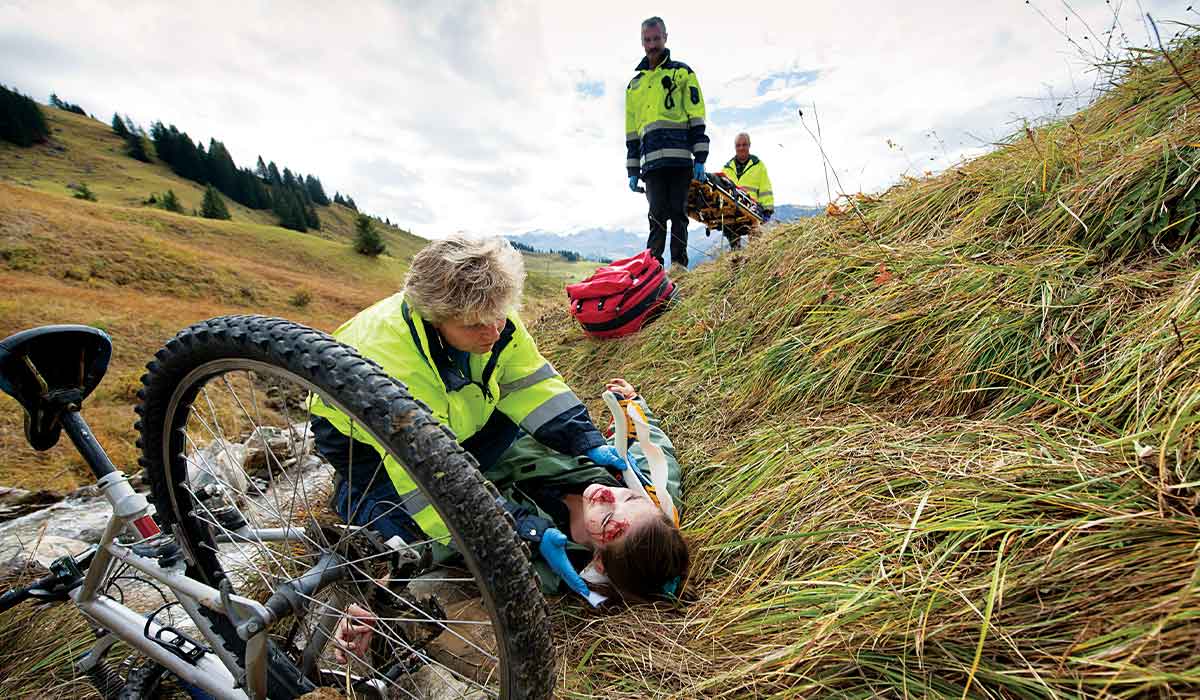 Paramedics tend to a cyclist with a head injury