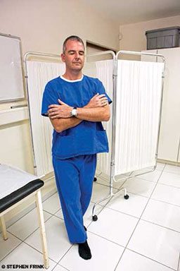 Patient in blue scrubs tries walking with eyes closed