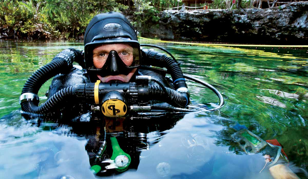 Rebreather diver pops his head out of the water