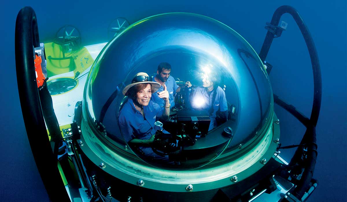 Three people travel in a submersible vehicle