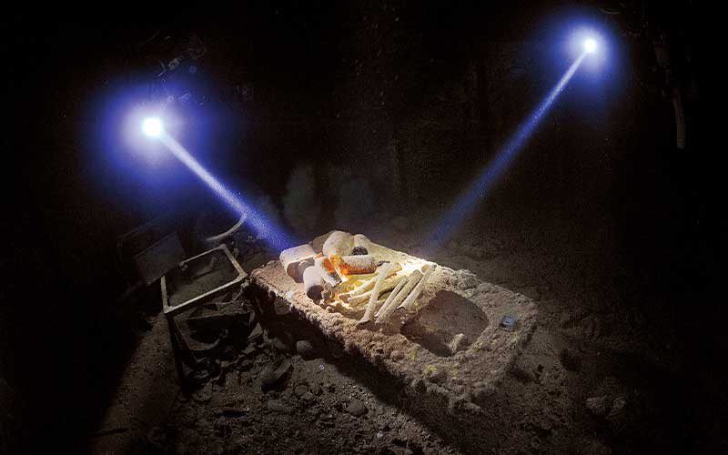 Two flashlight beams on a sunken hospital bed