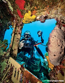 Underwater photographer outside a shipwreck