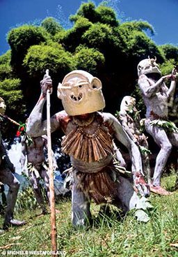 Villagers in masks and paint perform ancient rituals