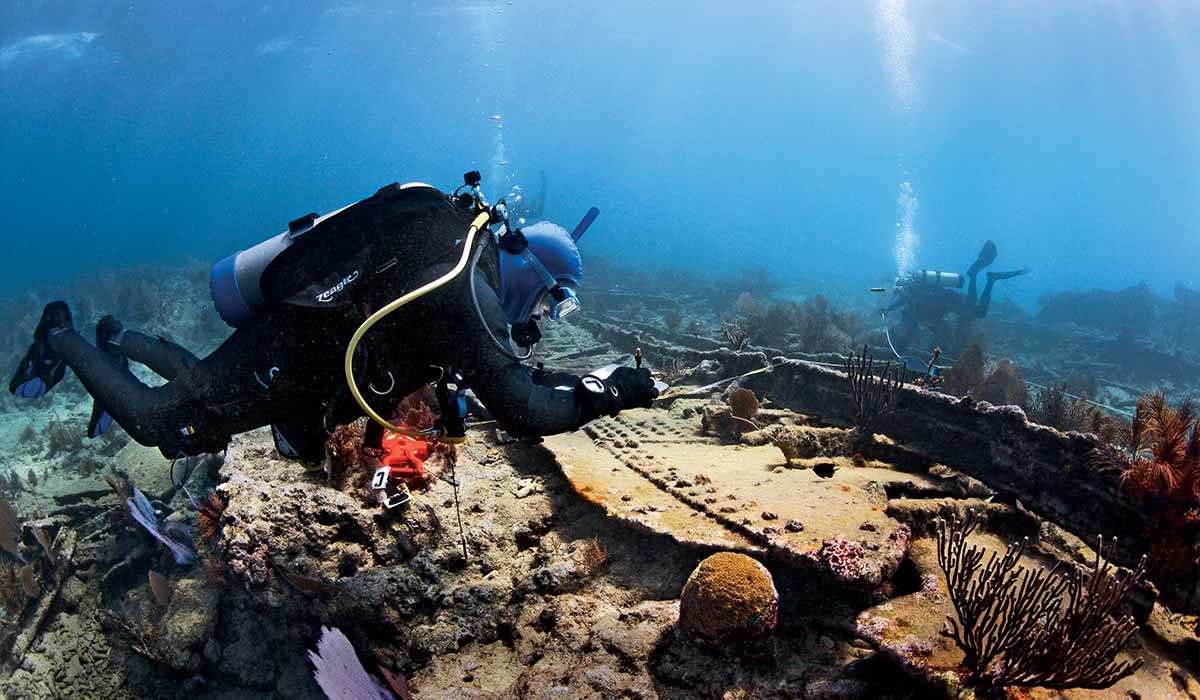 Volunteer diver takes notes on a shipwreck
