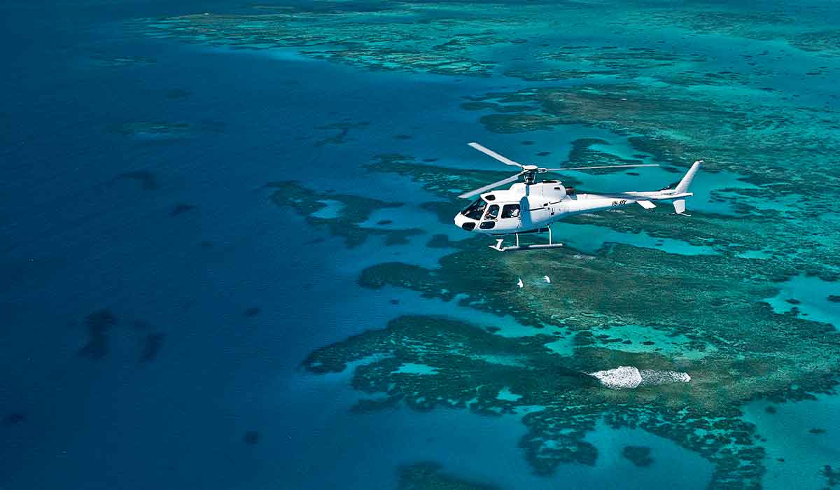 White emergency helicopter flies over remote islands