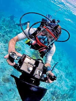 Dive photographer swims toward camera