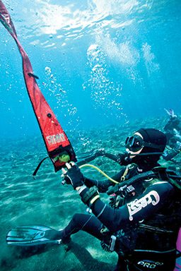 Diver inflates a red signaling marker