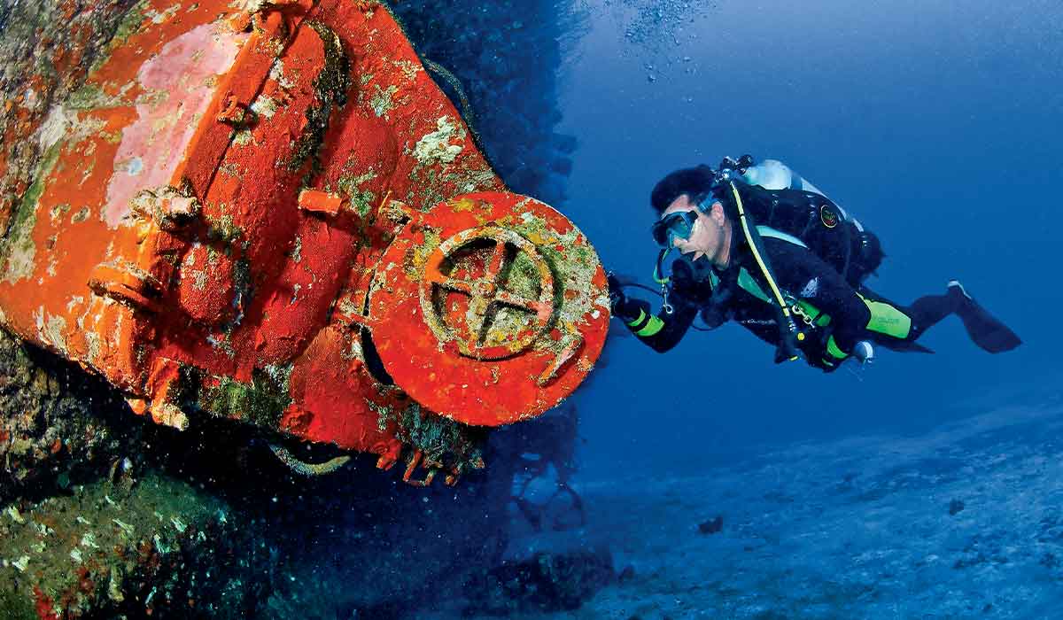 Diver opens the door of a shipwreck