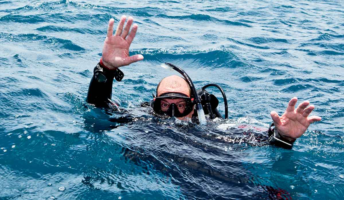 Diver pretends to drown with arms flailing about