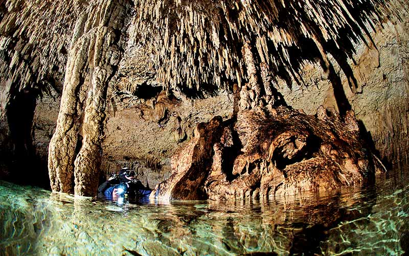 Diver surfaces inside an underground cavern