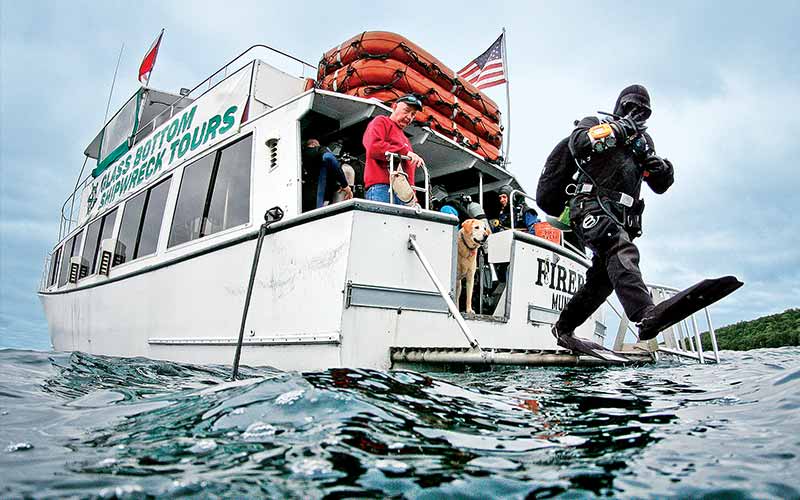 Drysuit diver steps off dive boat