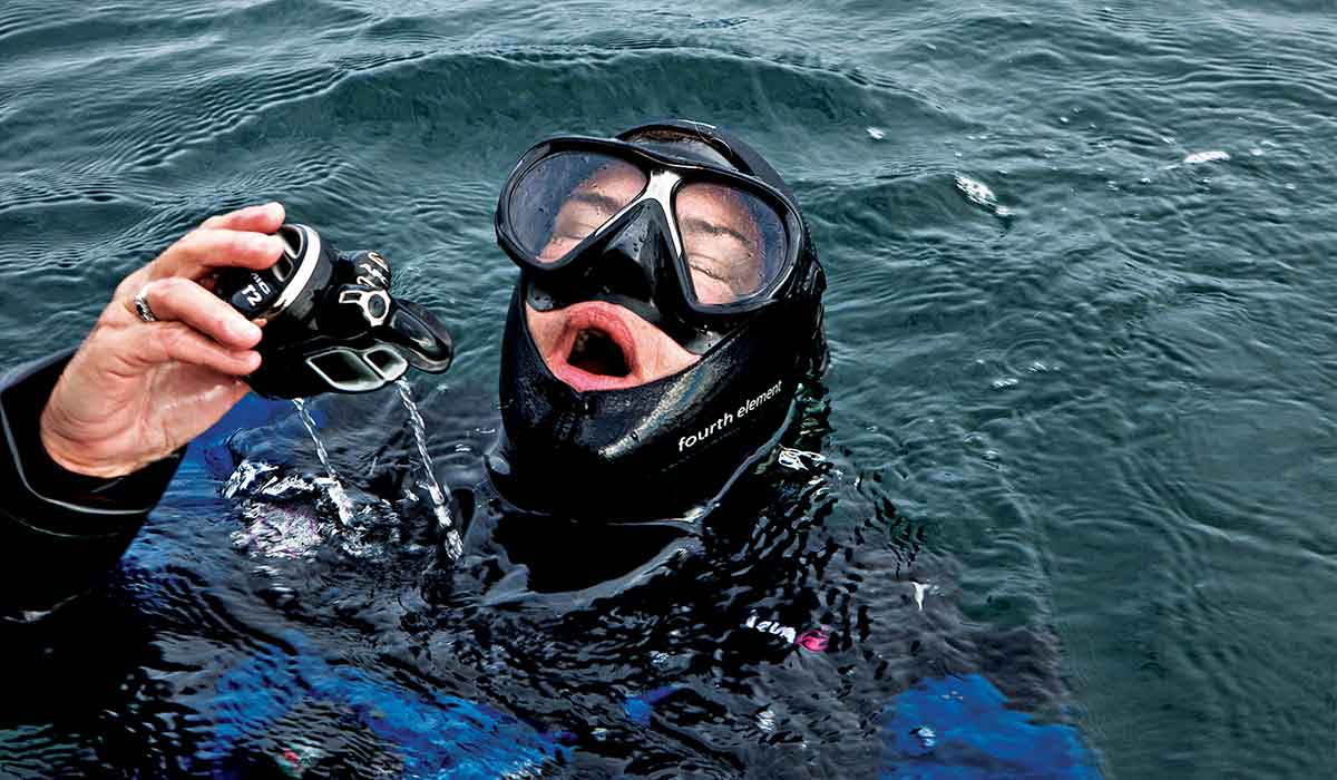 Drysuit diver surfaces and gasps for air