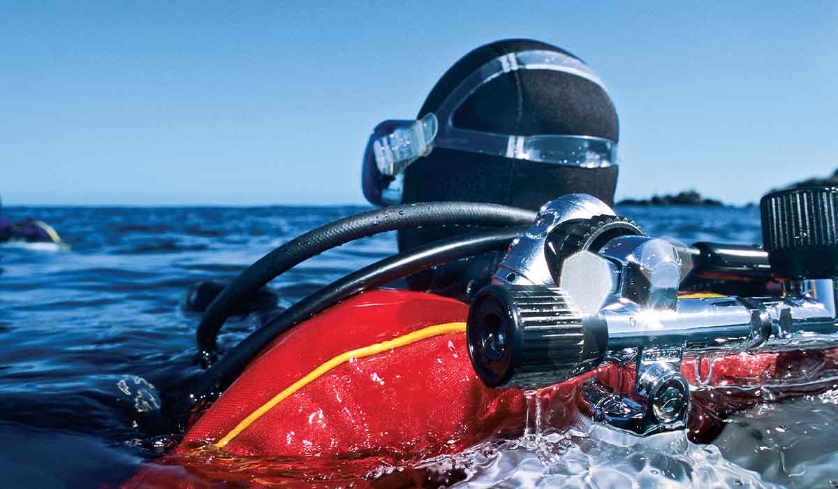 Drysuit diver surfaces and is wearing a backplate buoyancy system