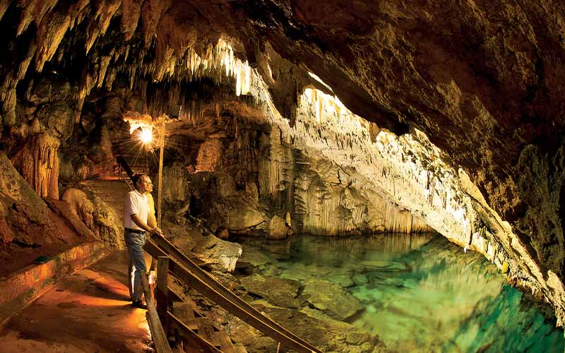 Tourists stop and take in the scenery of an underground cavern