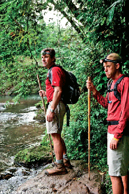 Two college students in red shirts on a hike