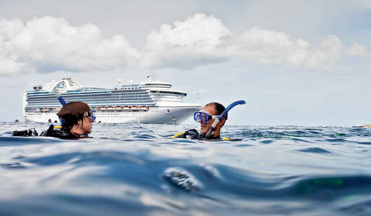 Two snorkelers surface outside their cruise ship