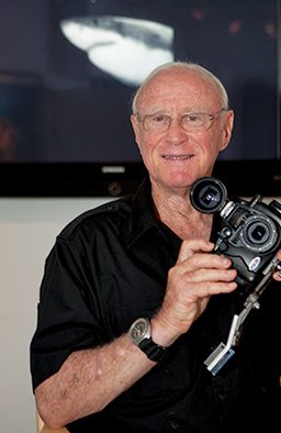 Headshot of Jerry Greenberg holding a camera