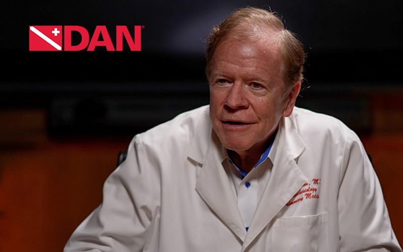 DAN-branded headshot of Dr. Richard Moon wearing a white lab coat