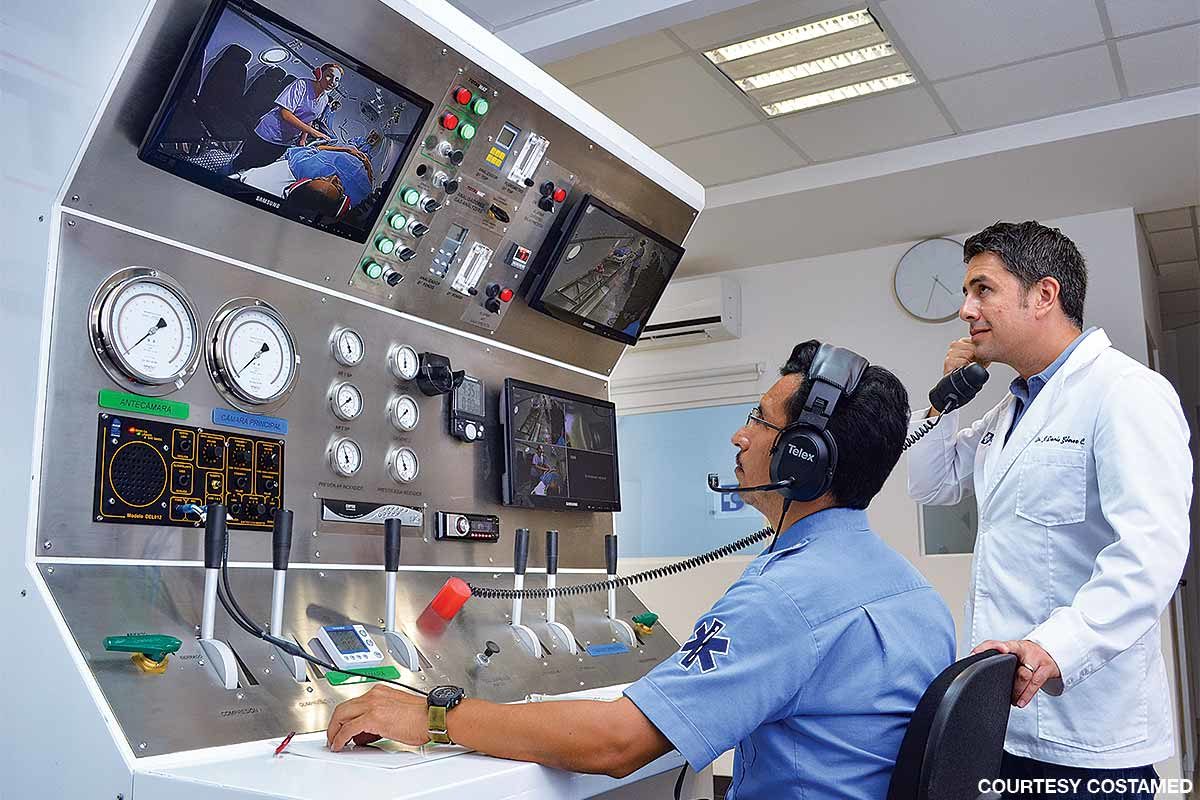 Staff members monitor and communicate with patients at the Costamed chamber.