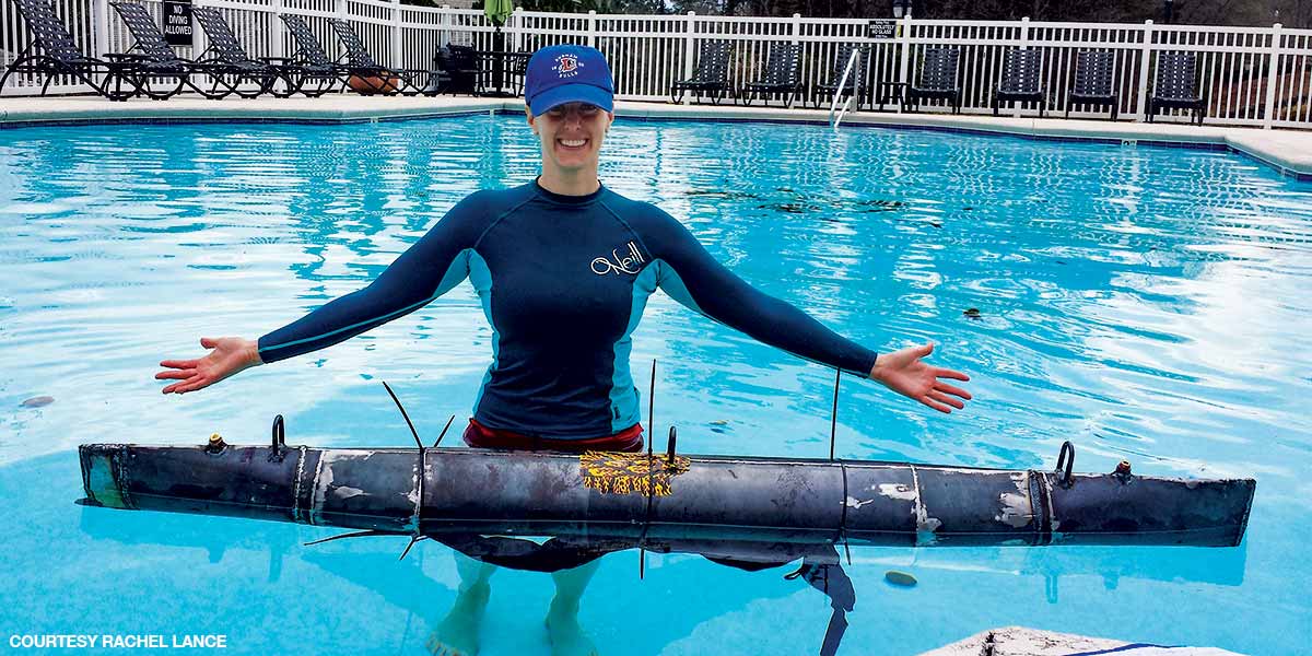 female researcher tests a long ship model in a swimming pool