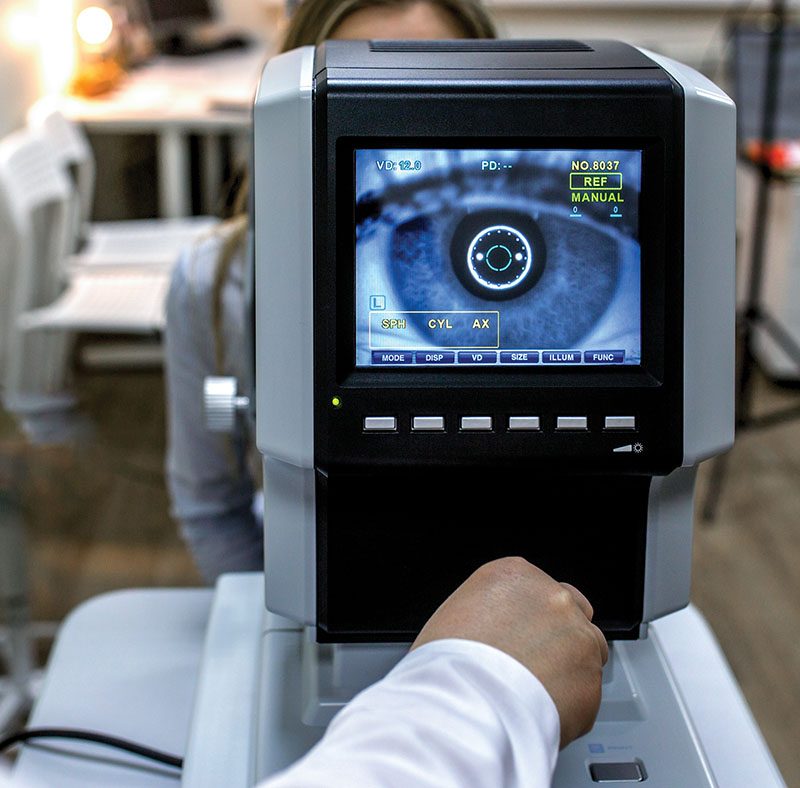 optometrist examining female patient