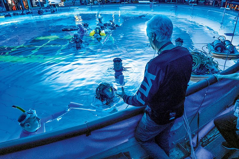 James Cameron chats with actor Jack Champion (Spider), as John Garvin (left) and Kirk Krack (right) prepare for an underwater scene