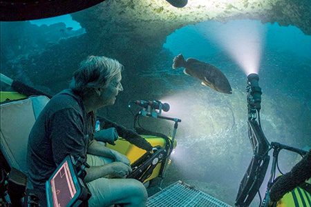 Dalio observing through dome of submersible.