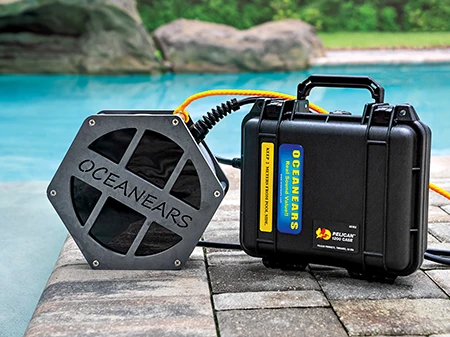 An underwater speaker attached to a cable dangles in the water at an optimized depth to transmit signals from the surface to divers underwater.