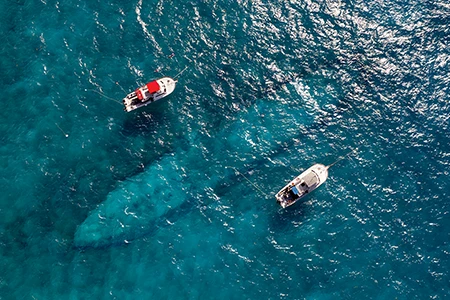 A pair of Key Largo dive boats are moored over the wreck of the Benwood.