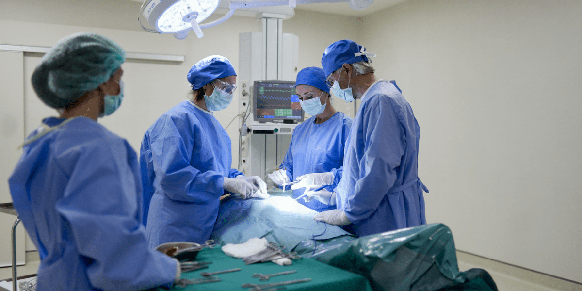 surgeons perform abdominal surgery