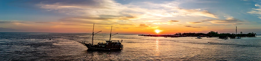 The liveaboard Arenui anchors off Derawan Island in preparation for a night dive at Darma Point.