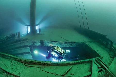A diver explores the cargo holds of the Samuel Mather.