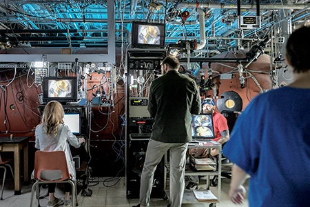 Hess observes the cameras that view the inside of the hyperbaric chamber