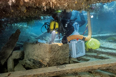 Parks Canada underwater archaeologist Marc-André Bernier methodically excavates a seamen’s chest in the crew living quarters on the lower deck of HMS Erebus.