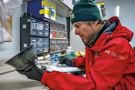 Charles Dagneau examines a ceramic bowl