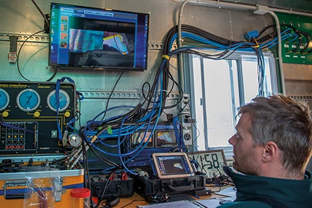 Boucher supervises dive operations from the support barge Qiniqtiryuaq. 