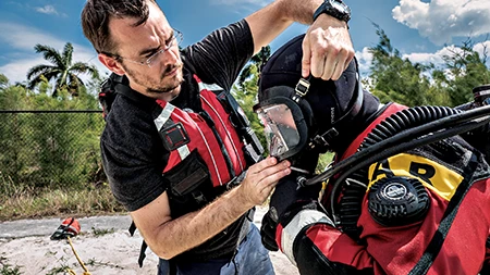 Hazmat drysuit thoroughly sealed and used with an integrated latex hood.