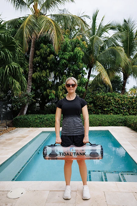 Woman starting the Halo position with feet shoulder-width apart.