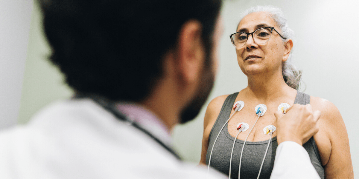 Mitral Valve Prolapse Patient talking with her doctor during a cardiopulmonary stress test on a hospital