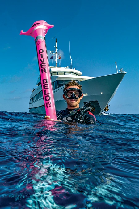 A Turks and Caicos Explorer II crew member helps with diver safety.