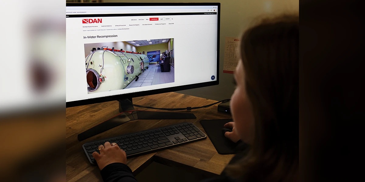 Emma Kate looking at a DAN In-Water Recompression article