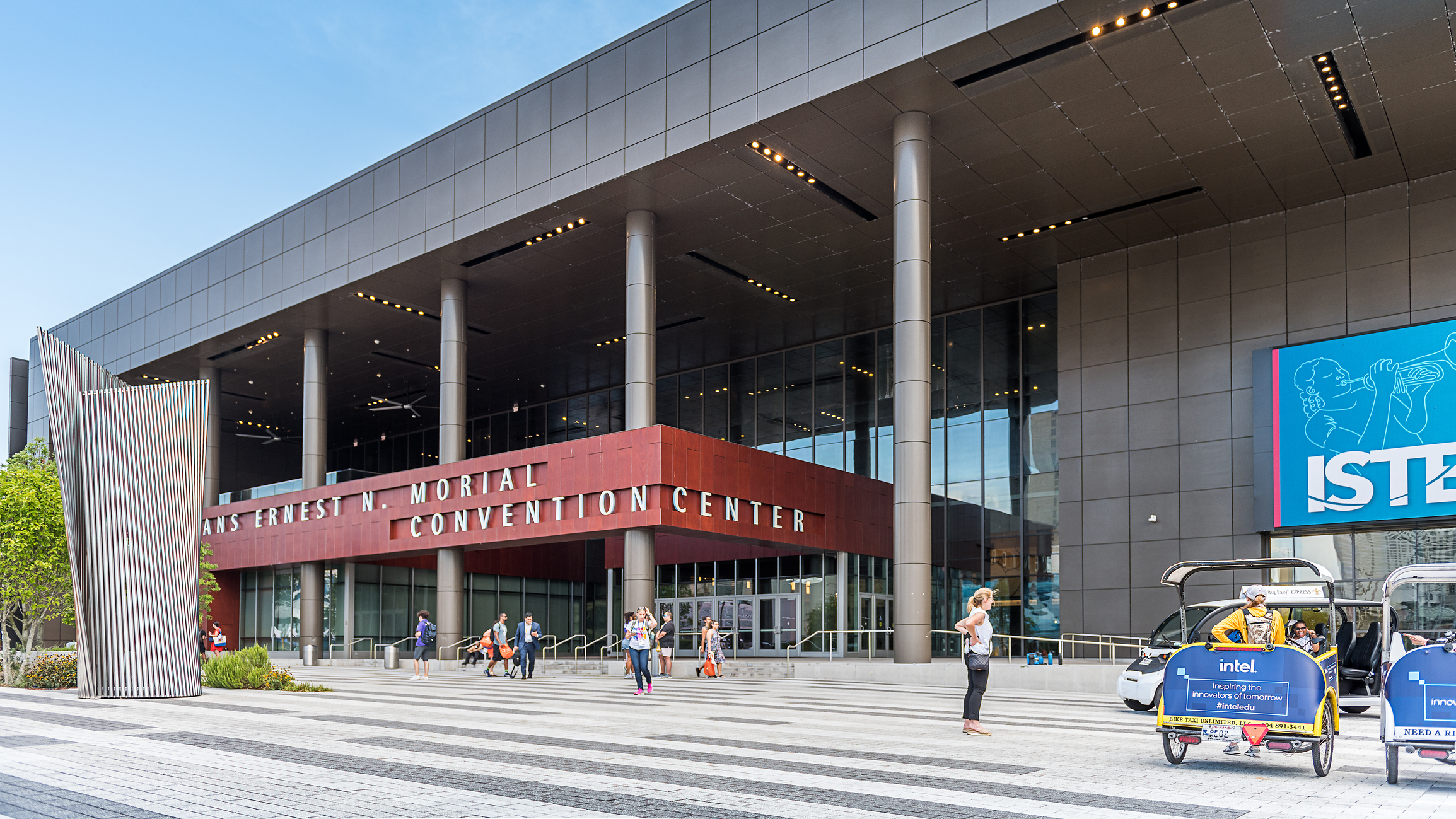 People walking around New Orleans Ernest N. Morial Convention Center. It is the 5th-largest facility of its kind in the United States and was named in honor of Ernest N. Morial, the city's first African American mayor.
