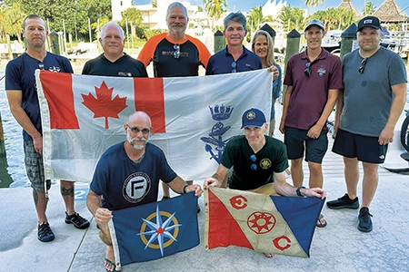 This group photo shows (front row, from left) Kelvin Davidson with the RCGS expedition flag, Ewan Anderson with the Explorers Club expedition flag, (back row, from left) Rob DeProy, Guy Shockey, Joseph Frey, Roger Lacasse, Brenda Altmeier, Matthew Lawrence, and Jason Cook.
