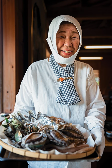 Hayashi presents a platter of raw abalone and other seafood at Ama Hut Satoumian.