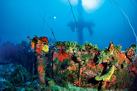A heavily corroded ship’s telegraph sits on the deck