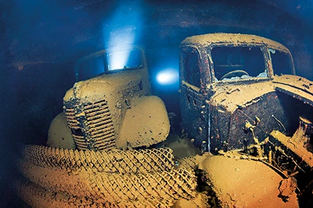 The corroded remains of trucks sit inside the cargo hold of the Hoki Maru.